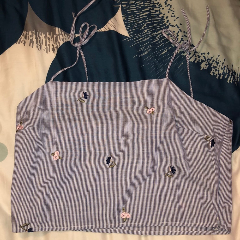 a blue and white tank top with flowers